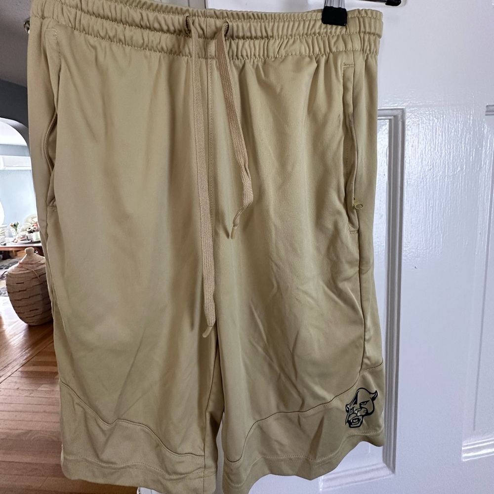 Men’s athletic shorts. Yellowish/tan color